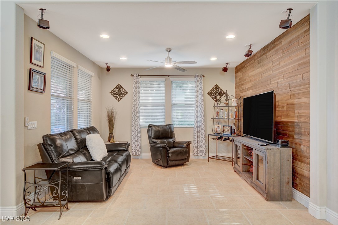 5741 Shadow Bend Drive Las Vegas, NV 89135 - Photo 22 of 78 Living room featuring ceiling fan, baseboards, and