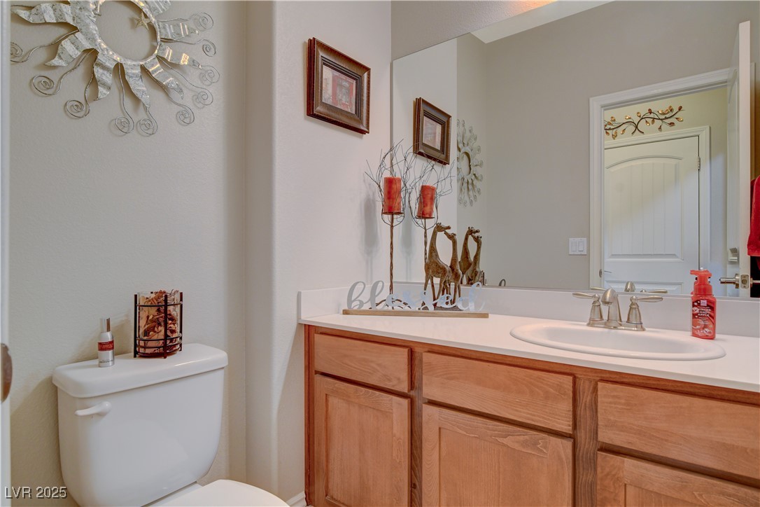 5741 Shadow Bend Drive Las Vegas, NV 89135 - Photo 26 of 78 Half bath with vanity and toilet