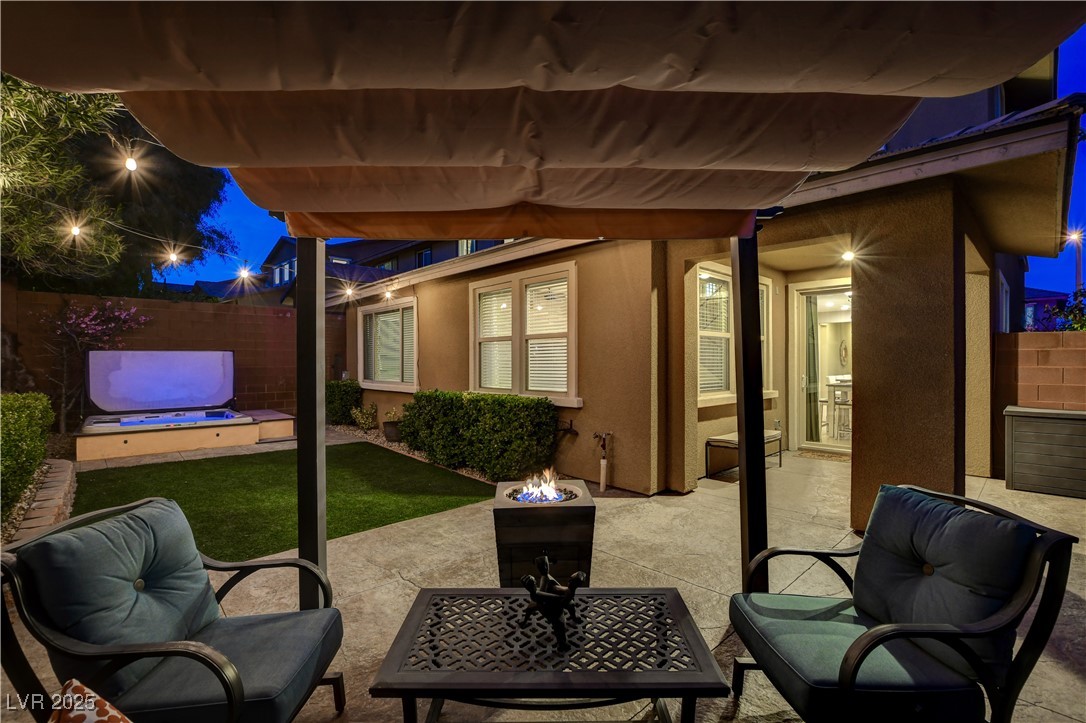 5741 Shadow Bend Drive Las Vegas, NV 89135 - Photo 53 of 78 Patio at twilight with fence and a fire pit