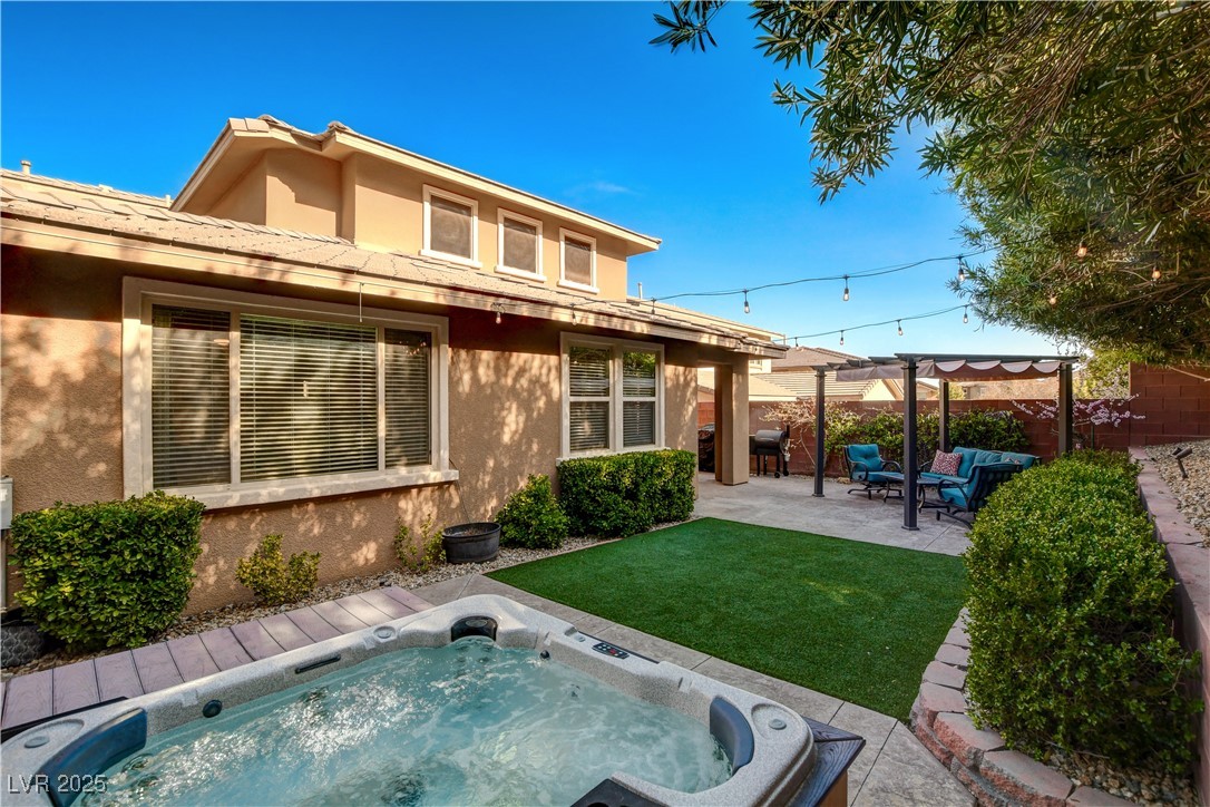 5741 Shadow Bend Drive Las Vegas, NV 89135 - Photo 56 of 78 Rear view of property with a yard, stucco siding,