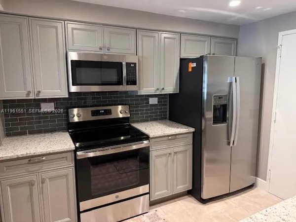a kitchen with a stove microwave and refrigerator