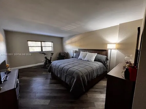 a spacious bedroom with a bed and window