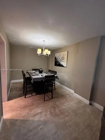 a living room with furniture a dining table and a piano
