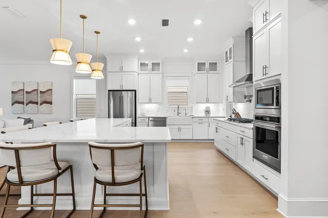 a kitchen with stainless steel appliances kitchen island granite countertop a sink and cabinets
