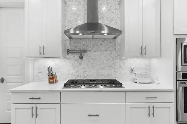 a kitchen with a stove and cabinets