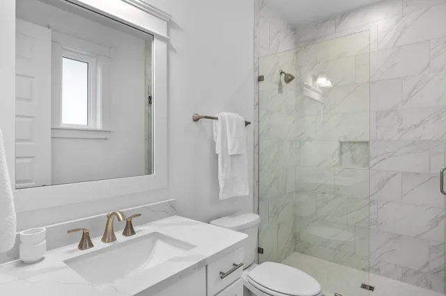 a bathroom with a sink toilet and shower