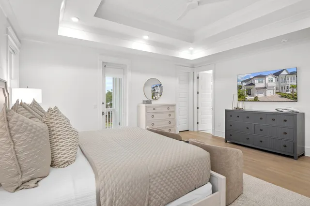 a spacious bedroom with a bed and a dresser