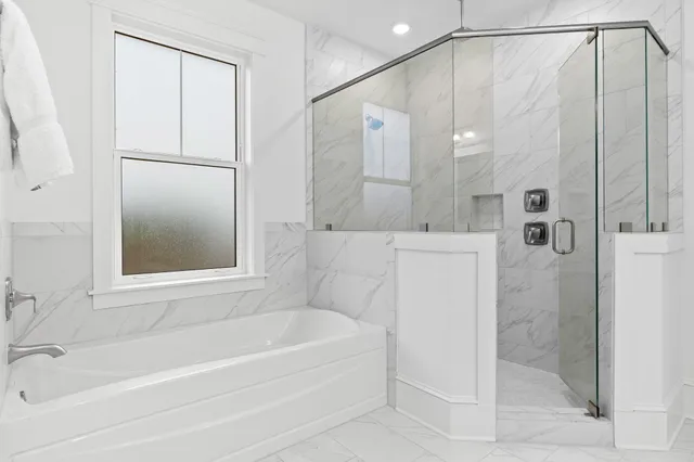 a bathroom with a bathtub and a shower