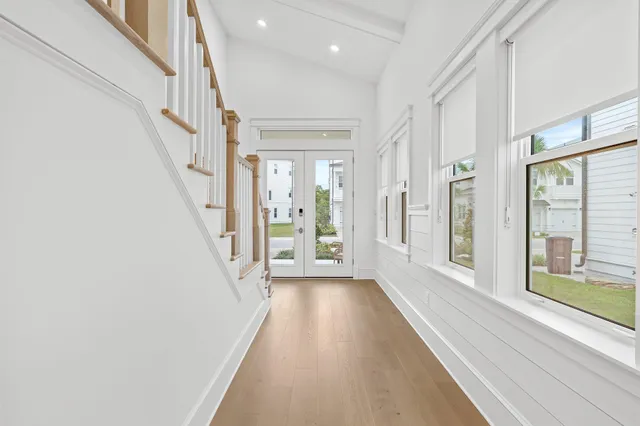 a view of a hallway with wooden floor and staircase