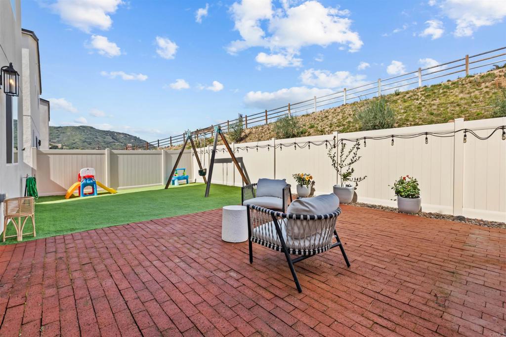 228 Hass Lane Fallbrook, CA 92028 - Photo 16 of 26 a view of a chairs and table on the wooden deck