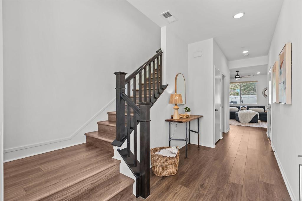 228 Hass Lane Fallbrook, CA 92028 - Photo 3 of 26 a view of a hallway with wooden floor and staircase