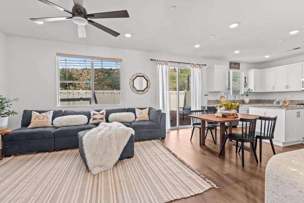 228 Hass Lane Fallbrook, CA 92028 - Photo 6 of 26 a living room with furniture a wooden floor and a window