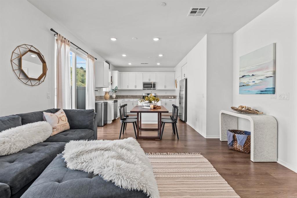 228 Hass Lane Fallbrook, CA 92028 - Photo 8 of 26 a living room with furniture and a dining table with kitchen view