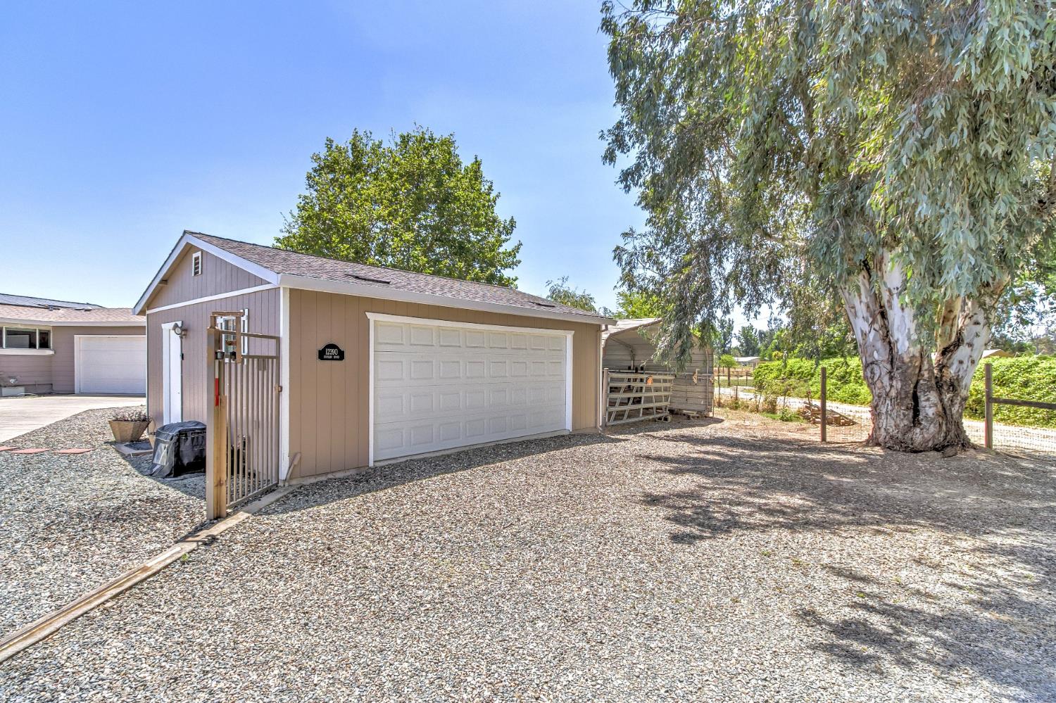 12390 Hobday Road Wilton, CA 95693 - Photo 63 of 92 a view of a house with a tree in front of it