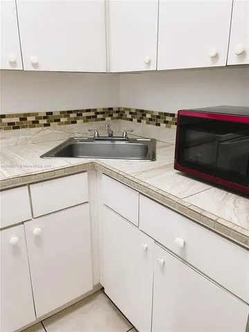 a kitchen with a sink and cabinets
