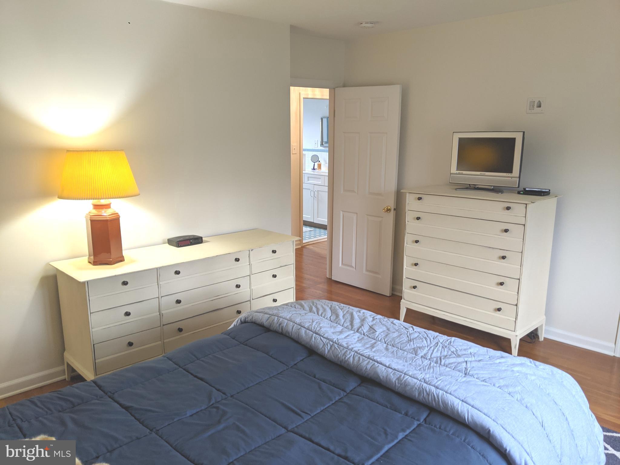 611 Andover Road Newtown Square, PA 19073 - Photo 17 of 27 a bedroom with a bed and a tv on dresser