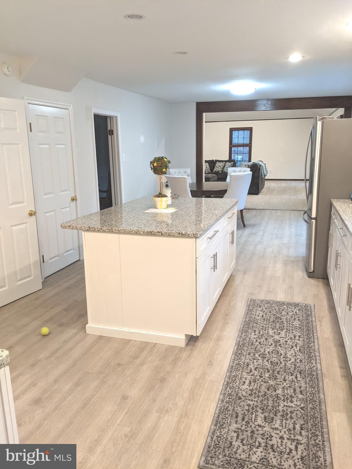 611 Andover Road Newtown Square, PA 19073 - Photo 10 of 27 a large room with kitchen island a sink wooden floor and glass door