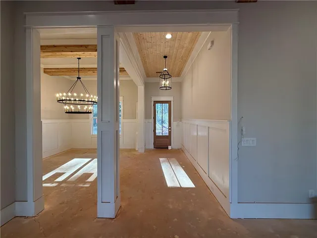 a view of an empty room with a fireplace and a window