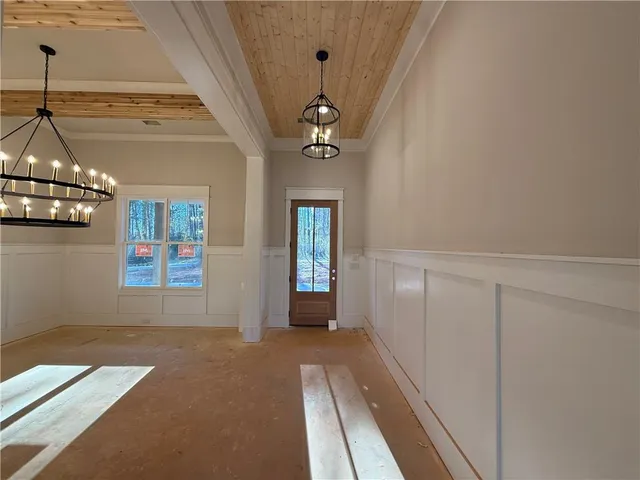 a view of an empty room with a fireplace and a ceiling fan
