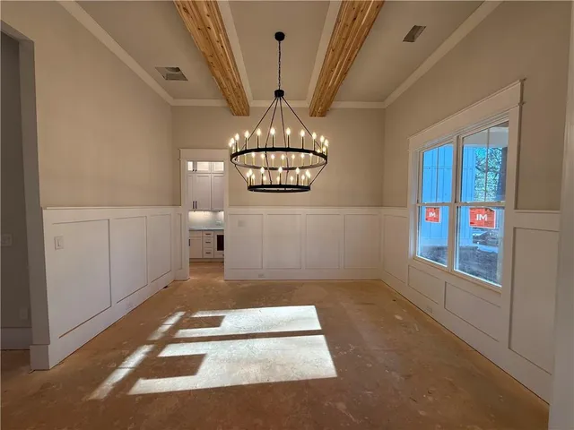 a view of an empty room with a fireplace and a window