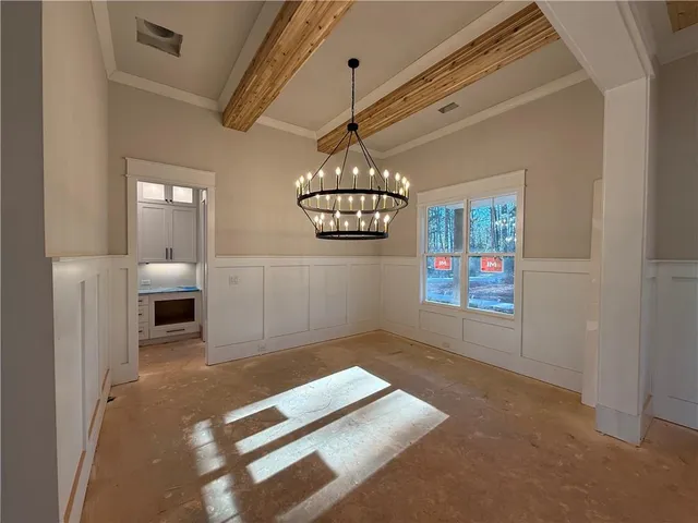 a view of an empty room with a fireplace and a window