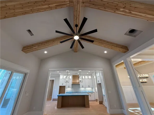 a kitchen with granite countertop white cabinets and window