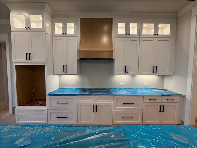 a view of dirt field with large trees