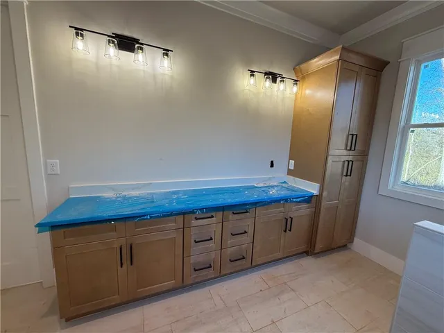 a bathroom with a granite countertop sink and a large mirror