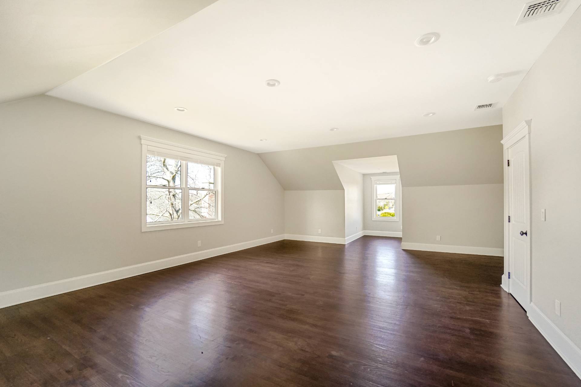 64 Romana Drive Hampton Bays, NY 11946 - Photo 15 of 29 an empty room with wooden floor and windows
