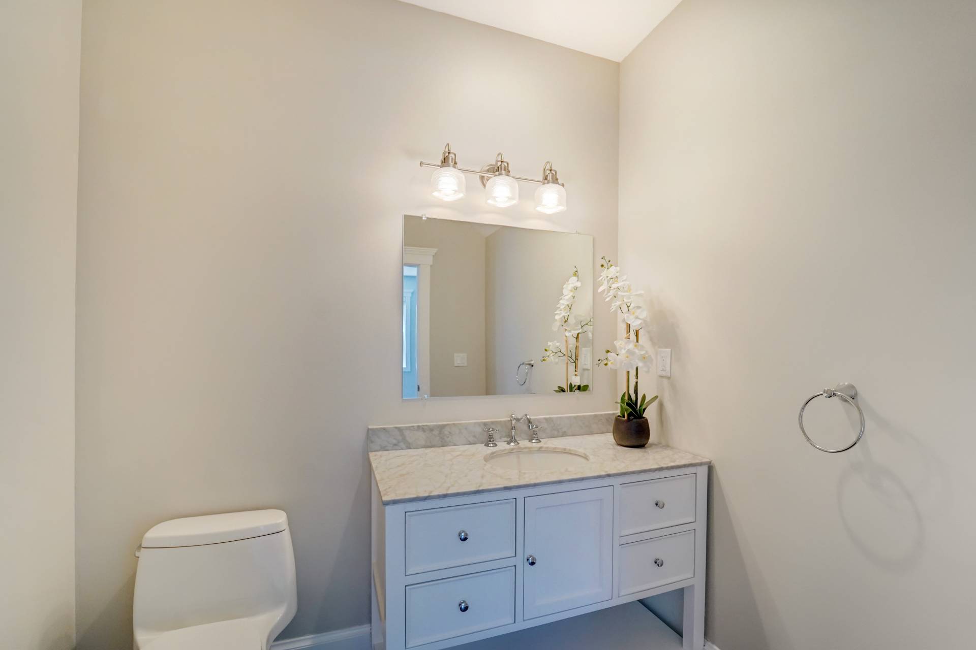 64 Romana Drive Hampton Bays, NY 11946 - Photo 17 of 29 a bathroom with a toilet sink and mirror