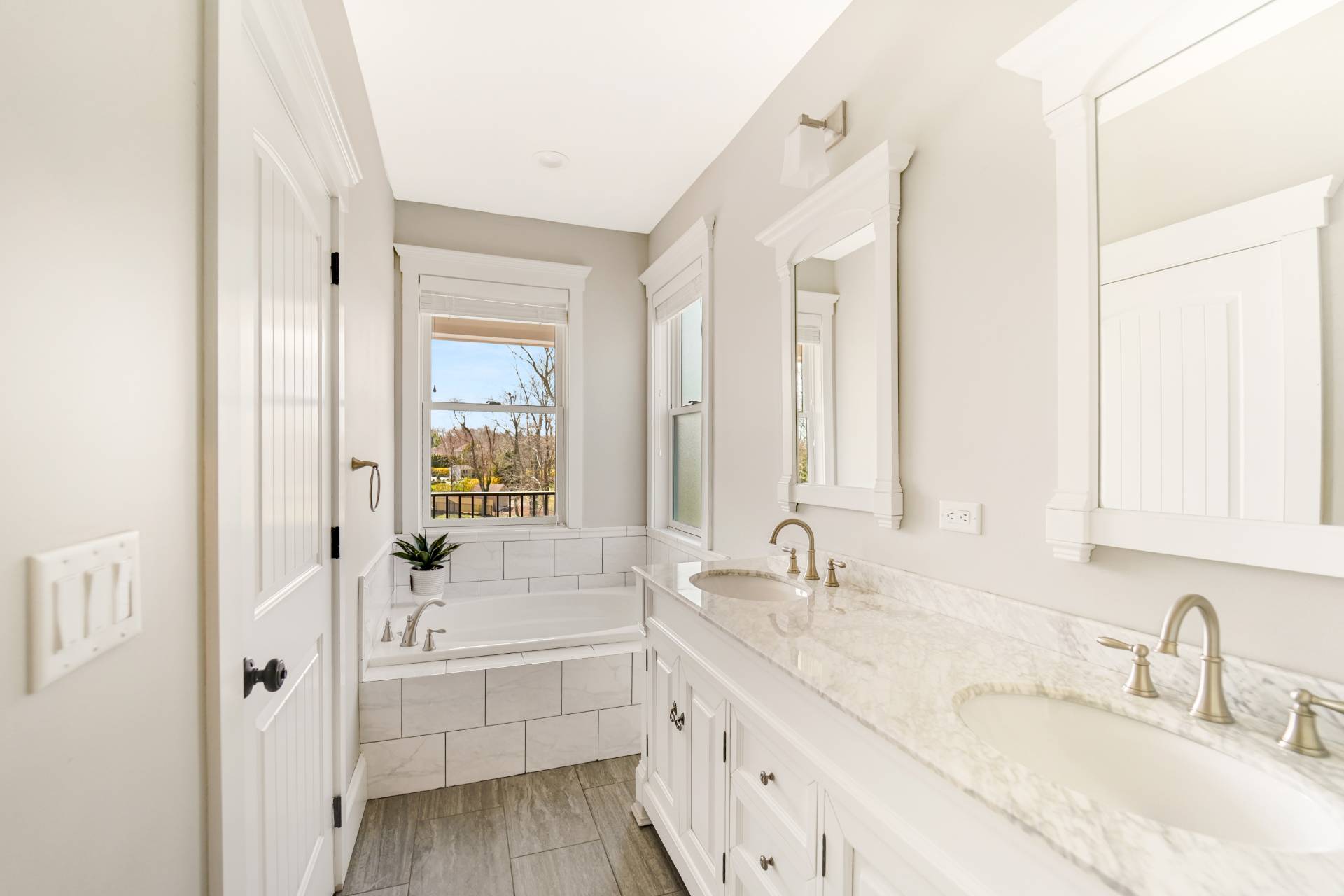 64 Romana Drive Hampton Bays, NY 11946 - Photo 21 of 29 a bathroom with a granite countertop sink mirror and a bathtub