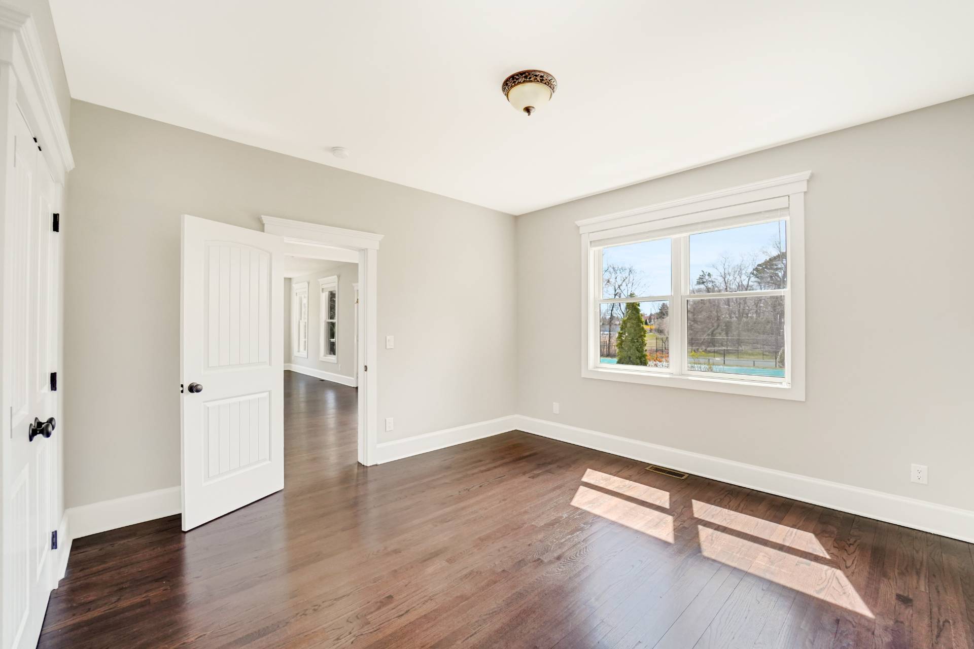 64 Romana Drive Hampton Bays, NY 11946 - Photo 24 of 29 a view of an empty room with wooden floor and a window