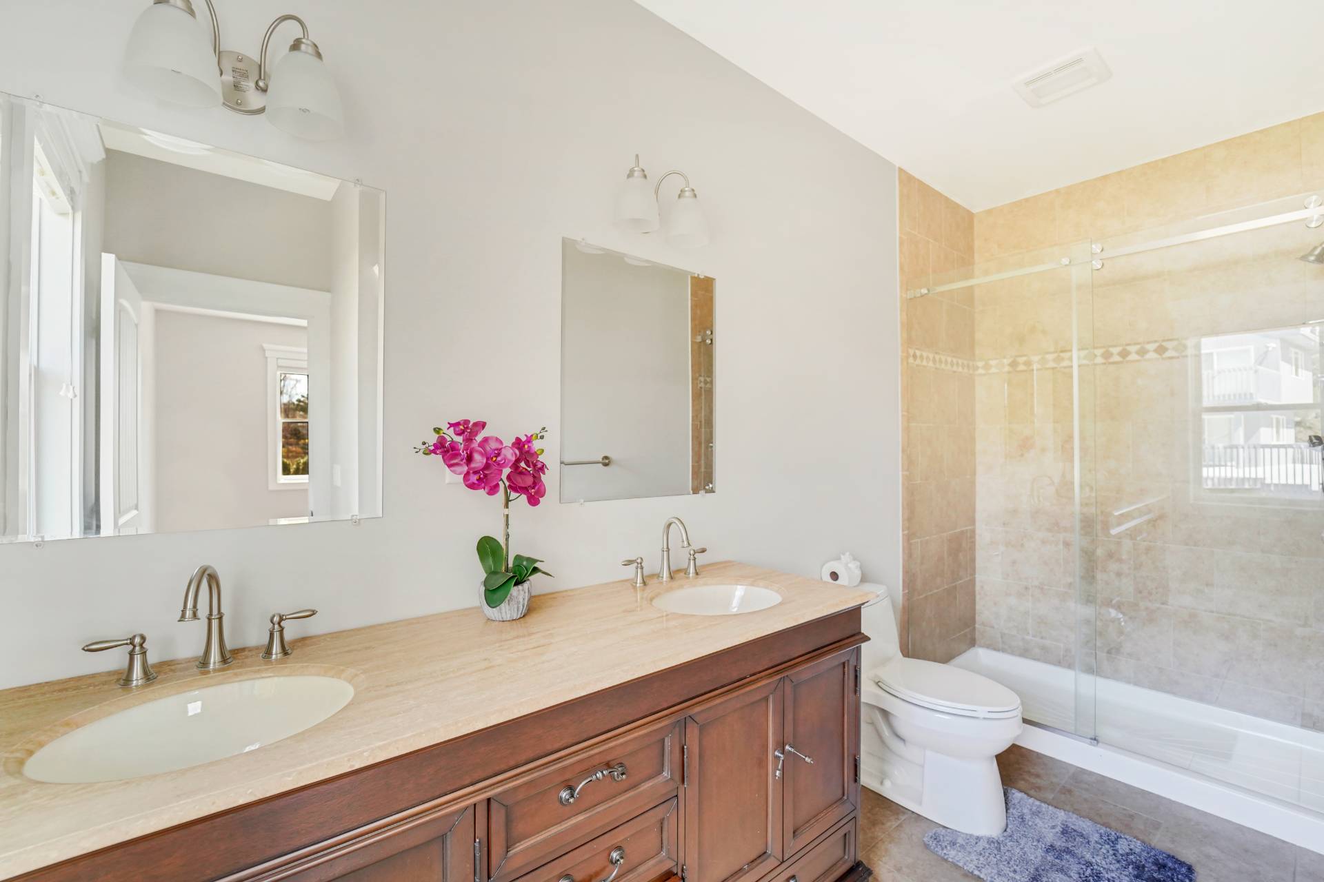 64 Romana Drive Hampton Bays, NY 11946 - Photo 25 of 29 a bathroom with a granite countertop sink a toilet and a shower