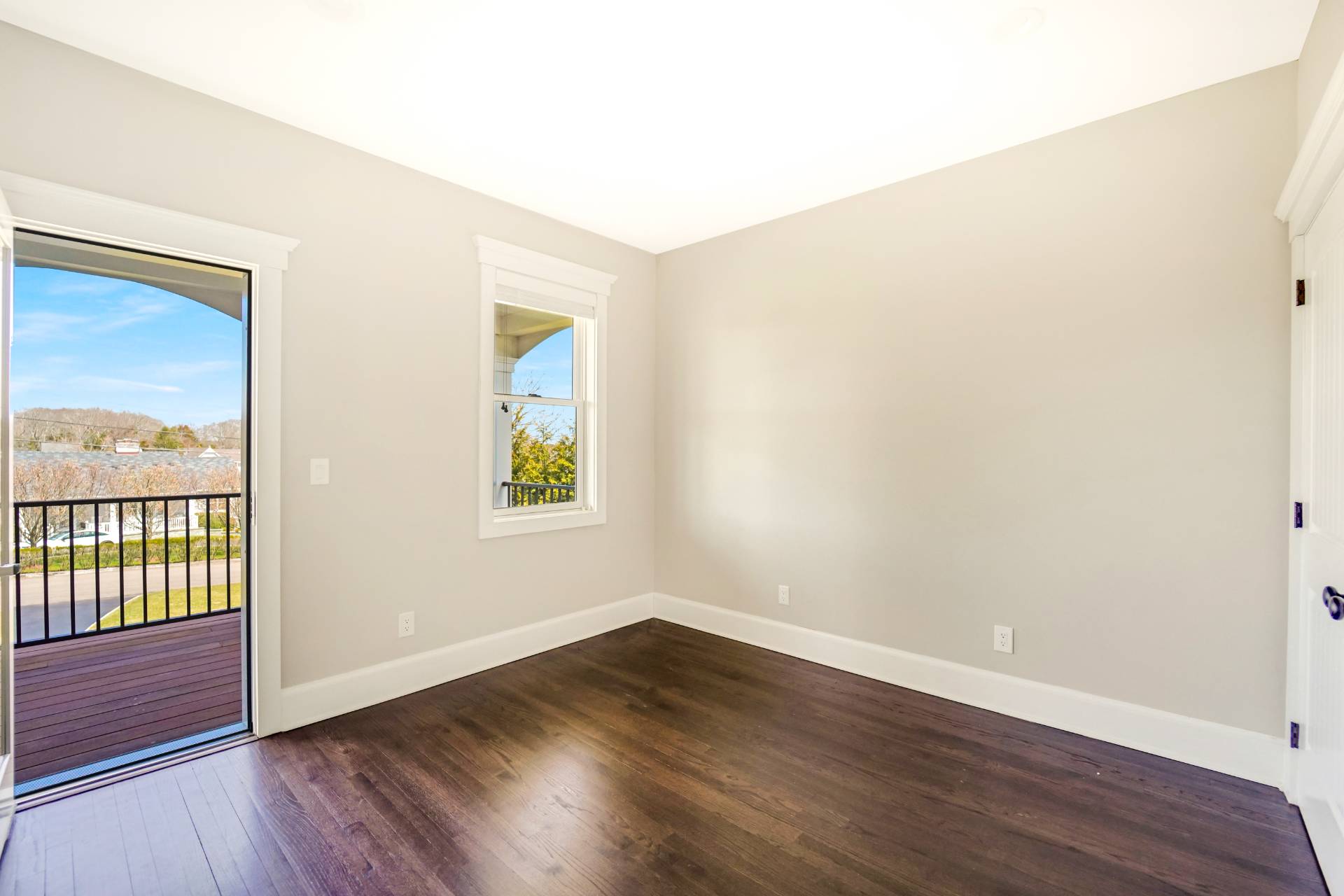 64 Romana Drive Hampton Bays, NY 11946 - Photo 27 of 29 an empty room with wooden floor and windows