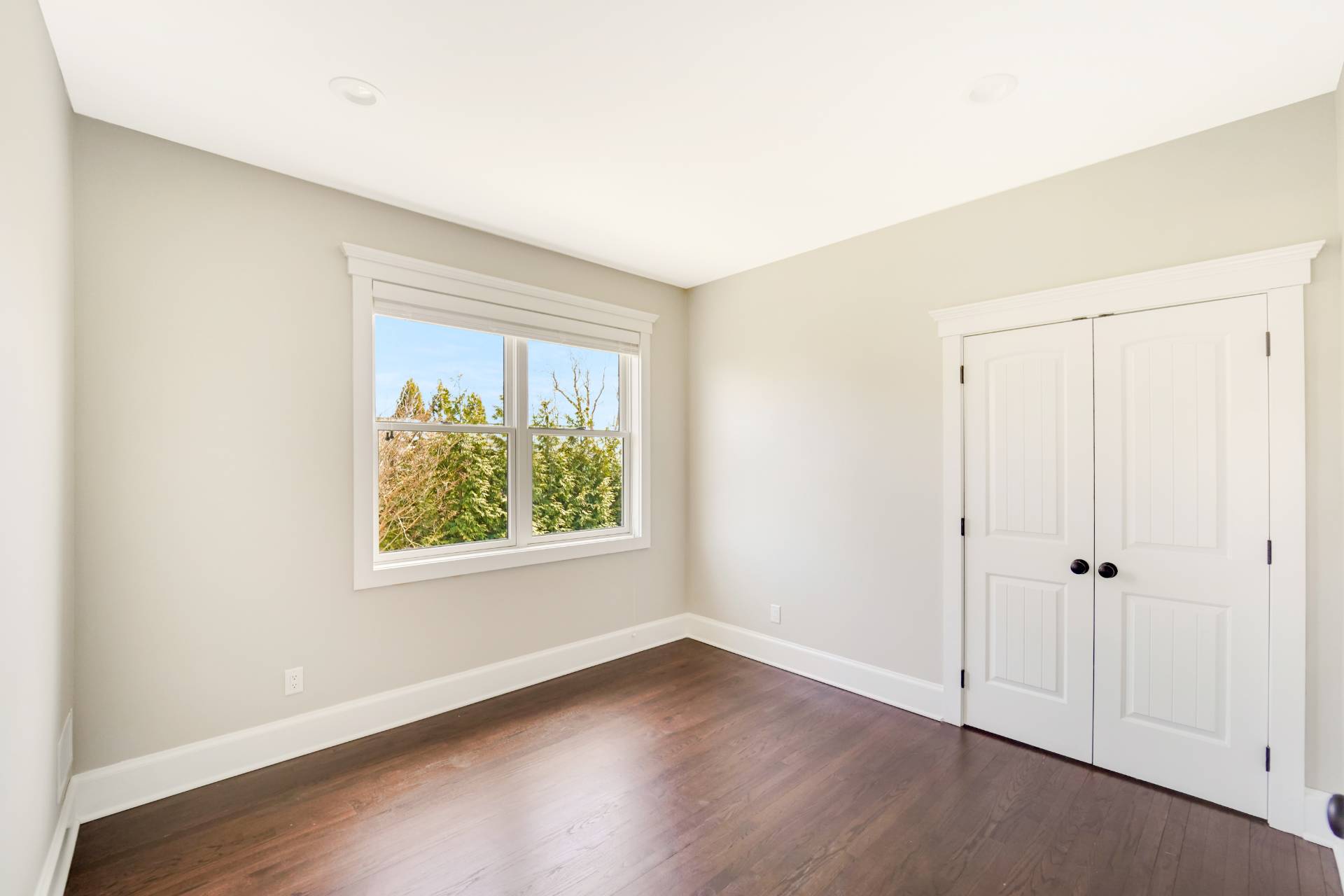64 Romana Drive Hampton Bays, NY 11946 - Photo 29 of 29 an empty room with wooden floor and windows