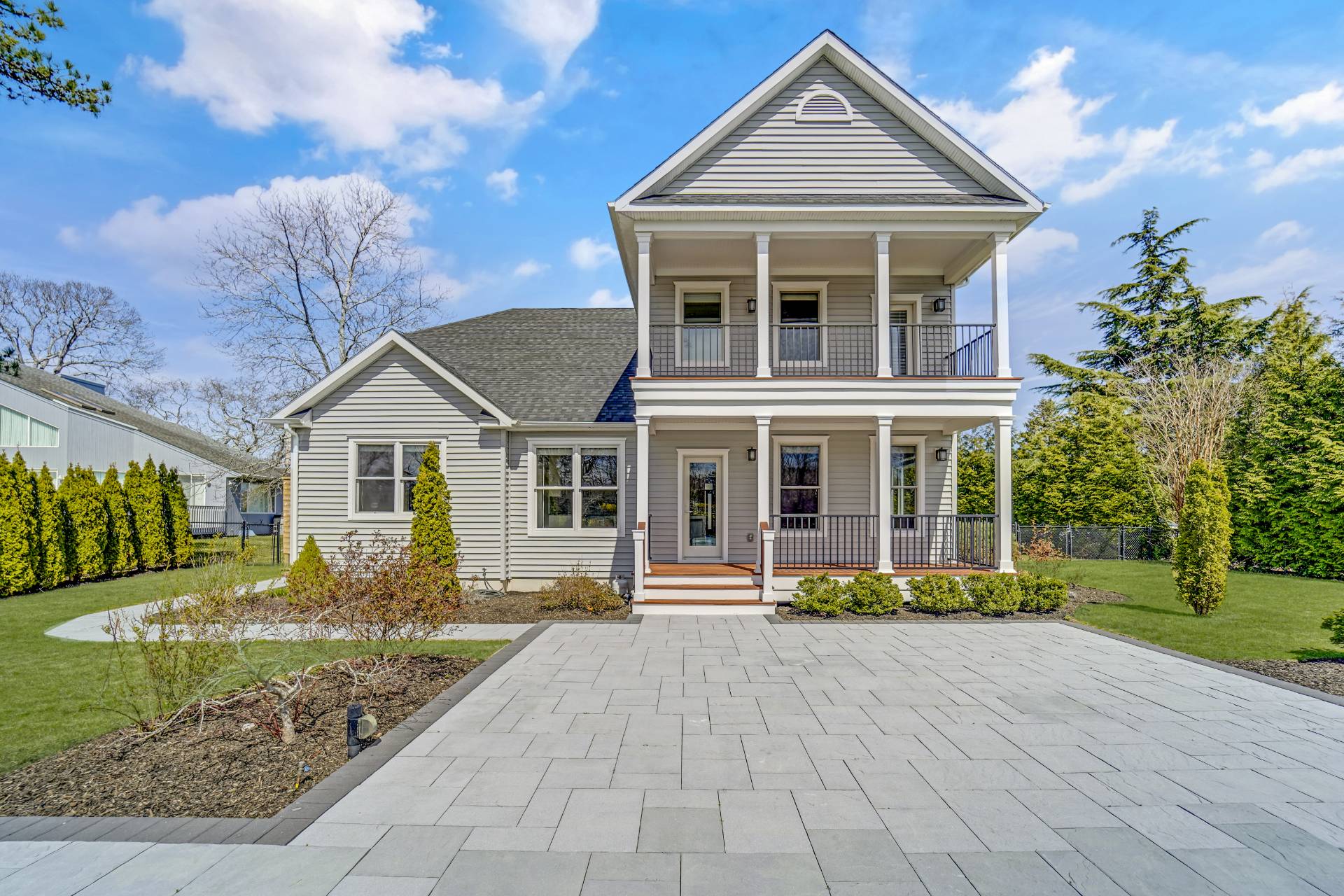64 Romana Drive Hampton Bays, NY 11946 - Photo 7 of 29 a front view of a house with garden