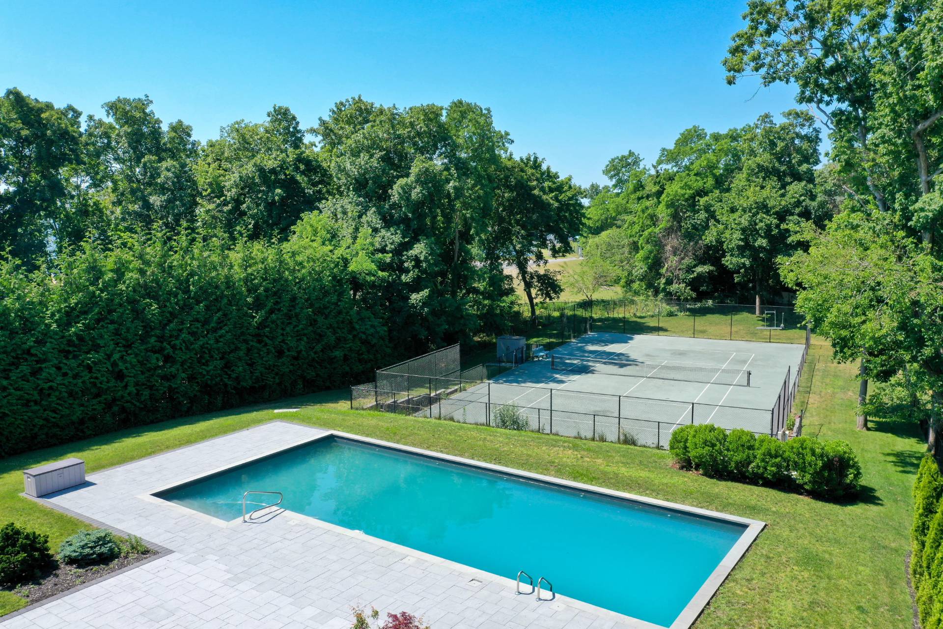 64 Romana Drive Hampton Bays, NY 11946 - Photo 8 of 29 a view of a backyard with a small pool
