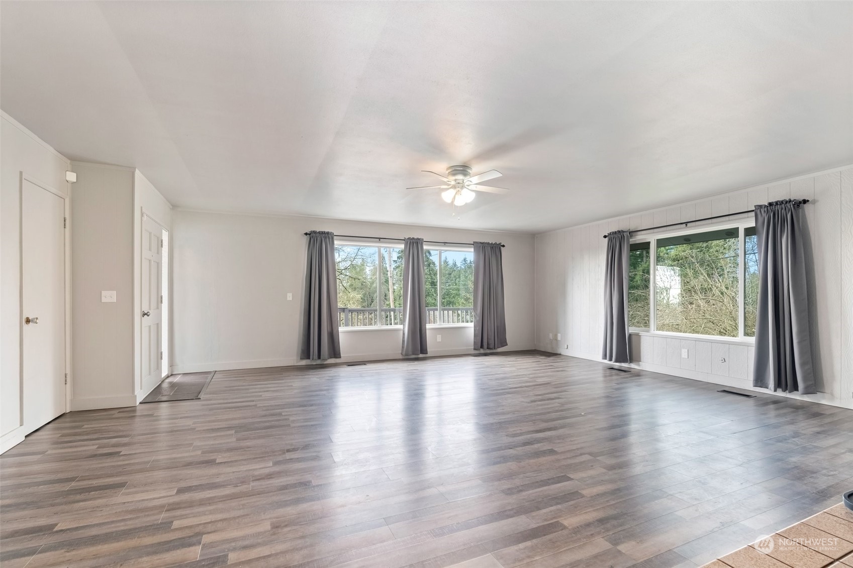 137 Wallace Road Chehalis, WA 98532 - Photo 7 of 39 a view of an empty room with wooden floor and a window