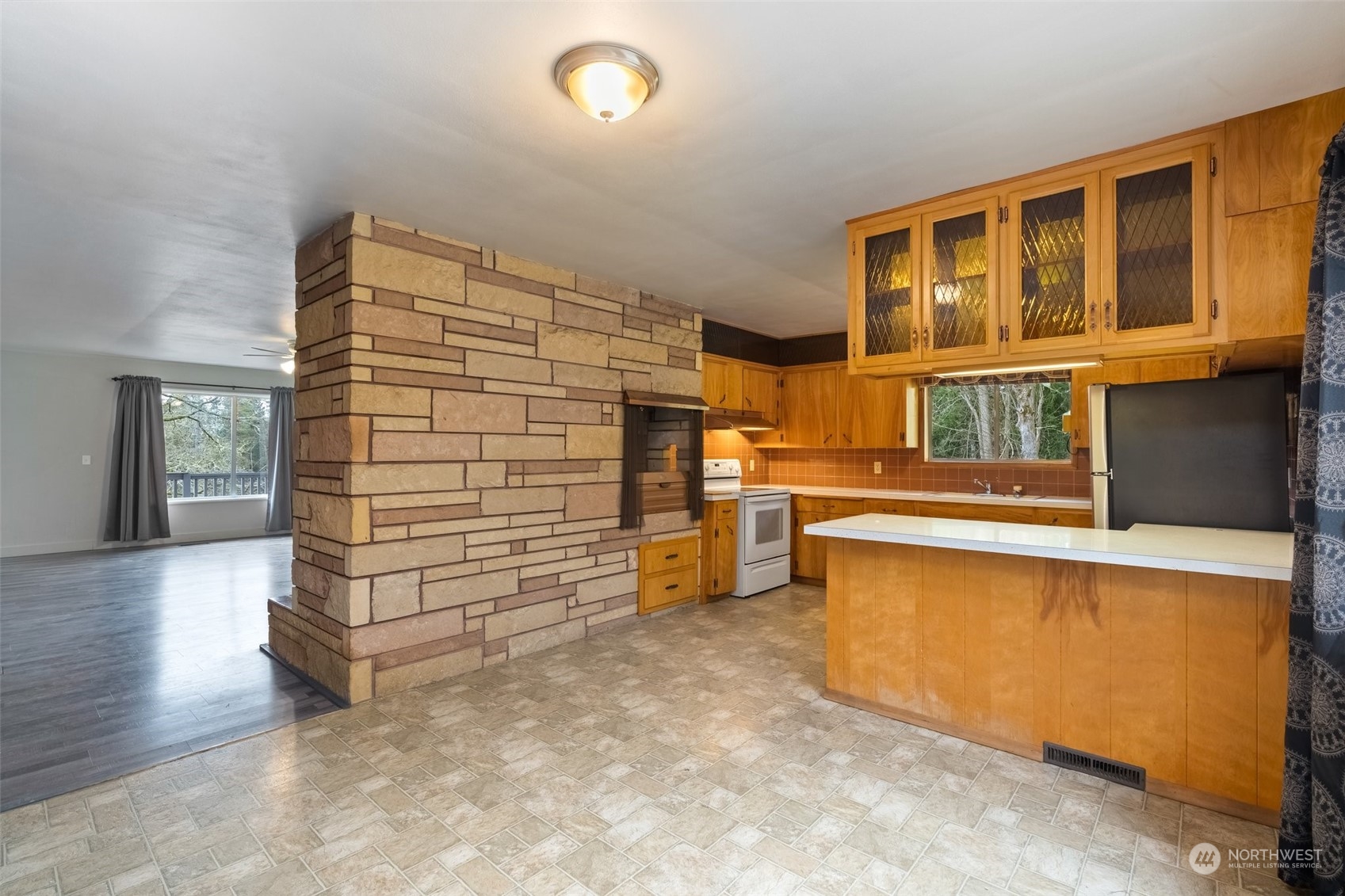 137 Wallace Road Chehalis, WA 98532 - Photo 8 of 39 a view of an empty room with wooden floor and a kitchen