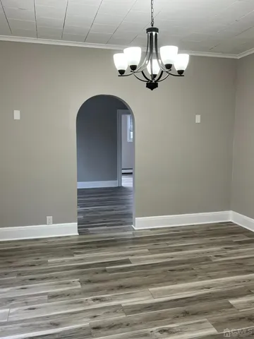 a view of a chandelier fan and wooden floor
