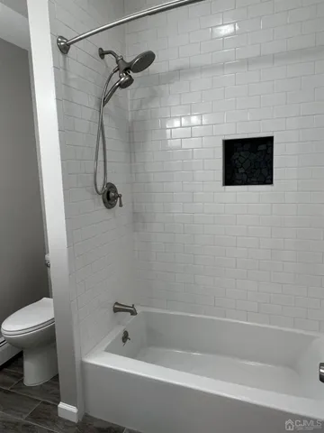 a bathroom with a bathtub and a toilet