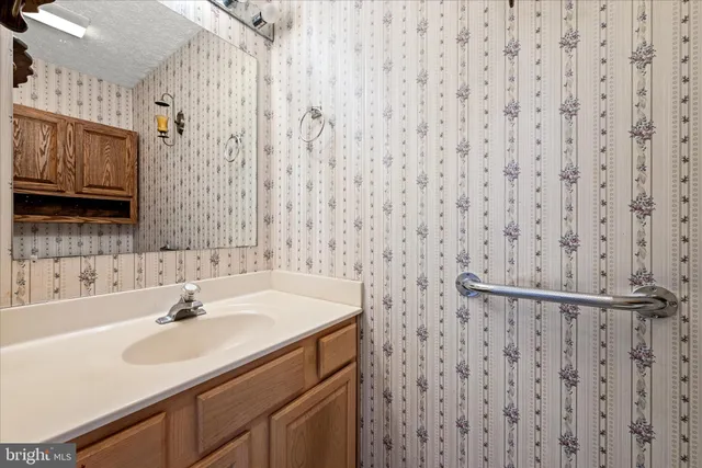 a bathroom with a sink a toilet a shower and a mirror