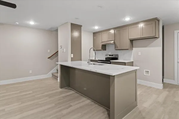 a kitchen with a sink cabinets and a refrigerator