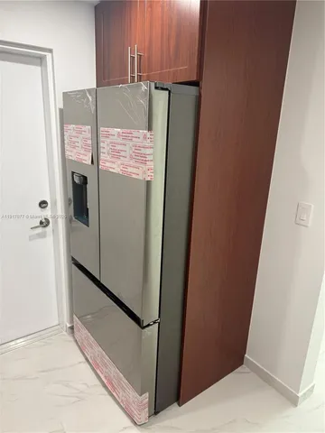 a white refrigerator freezer sitting in a kitchen