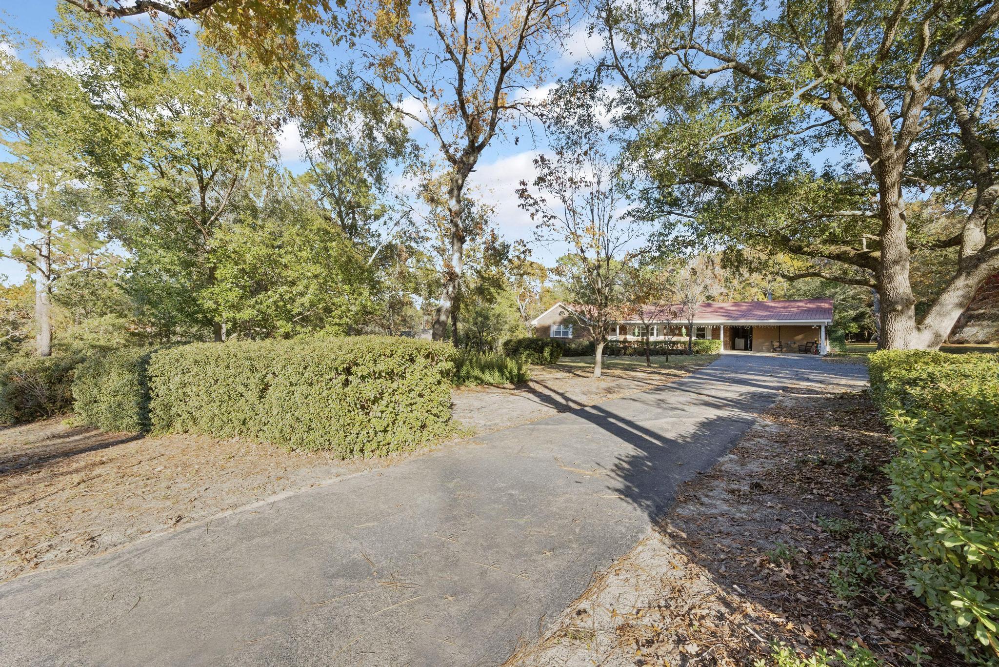 a view of a yard with wooden fence