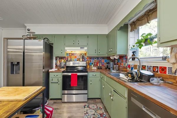 a kitchen with refrigerator and cabinets
