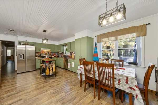 a view of a dining room with furniture window and outside view