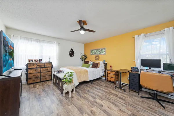 a bedroom with furniture and a flat screen tv