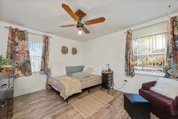 a bedroom with a bed and wooden floor