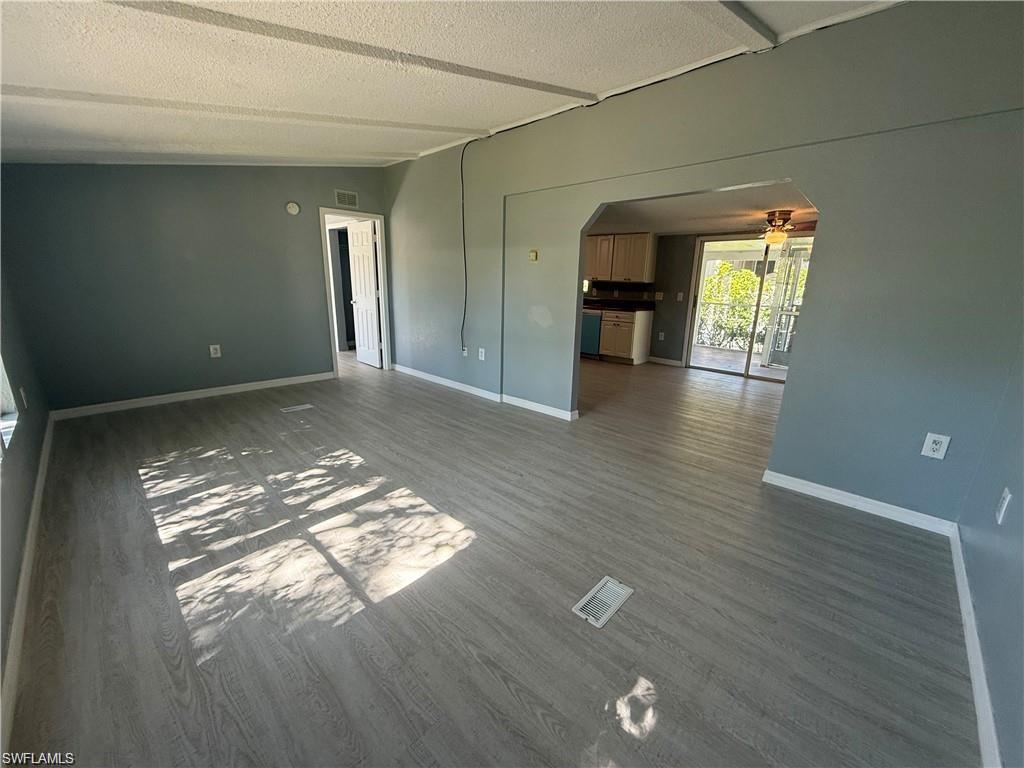 21 Ocho Rios Naples, FL 34114 - Photo 1 of 5 a view of livingroom and kitchen with hardwood floor